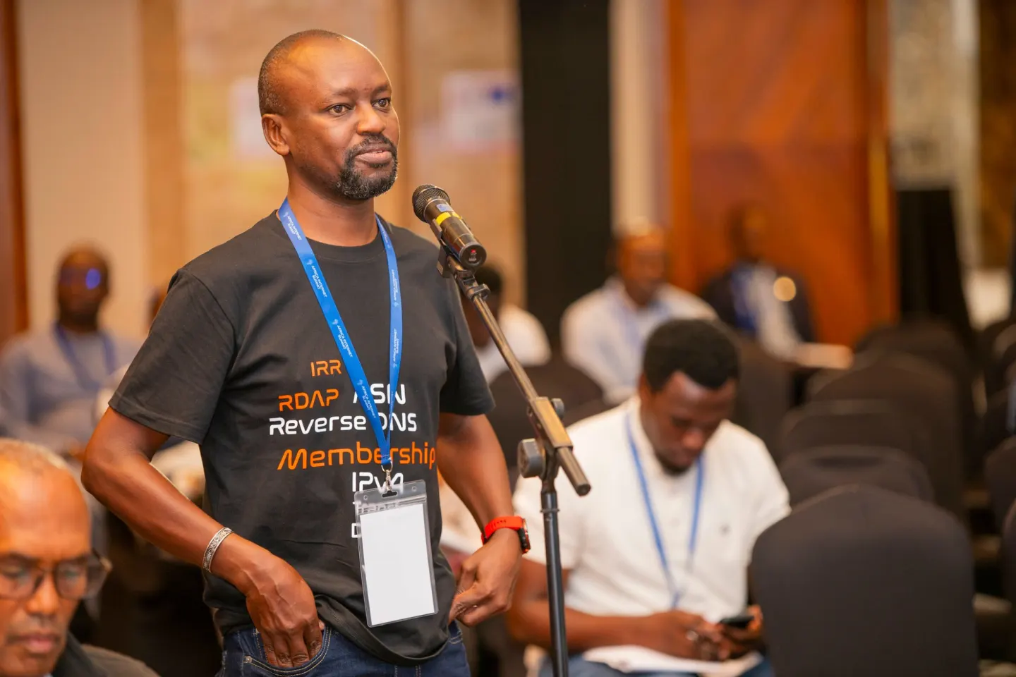A participant speaks from the floor microphone at AFRINIC-37